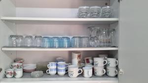 a shelf full of glass jars and other items at Elpida Lemon Garden House in Limassol