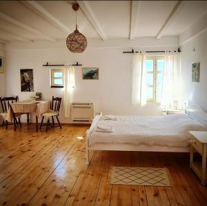 a bedroom with a bed and a table with chairs at Dembelija Rooms in Virpazar +52 photos