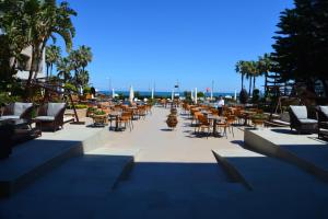 a group of tables and chairs in a patio at Fame Residence Kemer & Spa in Kemer