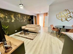 a living room with a couch and a table at City Center Accommodation - 310 in Reşiţa