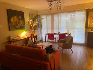 uma sala de estar com um sofá, cadeiras e uma mesa em Appartement Monseigneur em Vannes