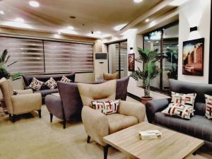 a living room with couches and a table at Panorama Amman Hotel in Amman