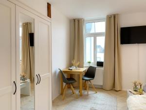 um quarto com uma mesa e duas cadeiras e uma janela em Elbnahe Ferienwohnung mit 2 Schlafzimmern em Coswig