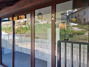 a glass door with a view of a balcony at Nortra apartment in Tolmin