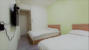 Postel nebo postele na pokoji v ubytování Fengchia Bichon B&B
