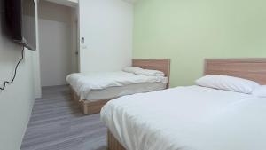 Postel nebo postele na pokoji v ubytování Fengchia Bichon B&B
