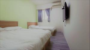 Postel nebo postele na pokoji v ubytování Fengchia Bichon B&B
