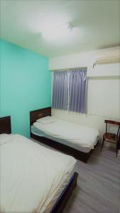 Postel nebo postele na pokoji v ubytování Fengchia Bichon B&B