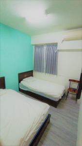 Postel nebo postele na pokoji v ubytování Fengchia Bichon B&B