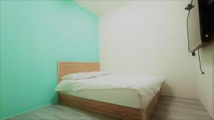 Postel nebo postele na pokoji v ubytování Fengchia Bichon B&B