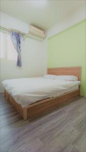 Postel nebo postele na pokoji v ubytování Fengchia Bichon B&B
