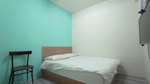Postel nebo postele na pokoji v ubytování Fengchia Bichon B&B
