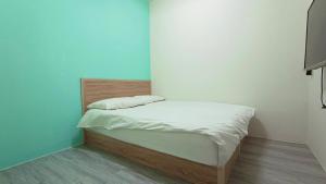 Postel nebo postele na pokoji v ubytování Fengchia Bichon B&B