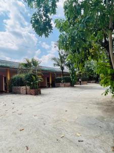 een gebouw met bomen midden op een binnenplaats bij เซเว่นอิน in Ban Huai Phlu