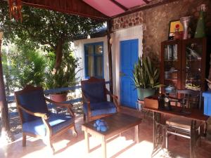 a porch with two chairs and a table at Mila Pansiyon in Cıralı