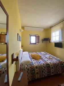 Postel nebo postele na pokoji v ubytování Notti Etrusche a Sovana