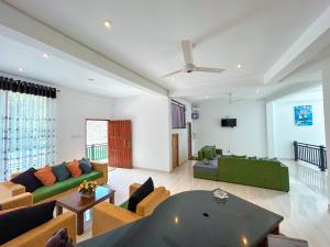 a living room with a couch and a table at Hotel Grand Resto in Katugastota