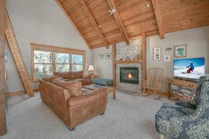a living room with a couch and a fireplace at Cabin In The Pines 11 in Keystone