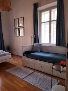 a bed in a room with a window at be at home with Philip & Marie in Klagenfurt