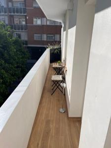 a balcony with a table and chairs on a building at Apartamento nuevo en Triana junto a Plaza de Cuba in Seville
