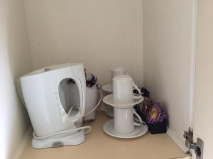 a small kitchen with a white mixer in a corner at Aberdeen Motor Inn in Geelong