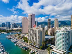 an aerial view of a city with boats in a harbor at *Remodeled Oceanfront in Waikiki - Ilikai Marina in Honolulu
