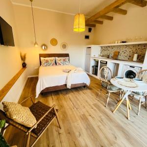 a bedroom with a bed and a table and chairs at Veronika's House in Pula