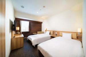 Postel nebo postele na pokoji v ubytování KOKO HOTEL Sapporo Ekimae + 21 fotografií