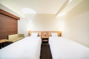 Postel nebo postele na pokoji v ubytování KOKO HOTEL Sapporo Ekimae