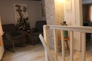 a living room with two chairs and a table at Ferienhaus Schatzliebe in Quedlinburg