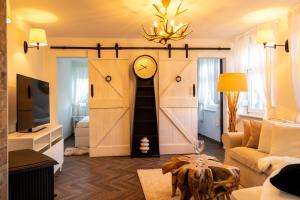 a living room with a barn door and a clock at Blablu - Ferienhaus Bäckerei Koch in Blankenburg