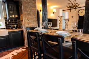 a dining room with a table with wine glasses at Blablu - Ferienhaus Bäckerei Koch in Blankenburg