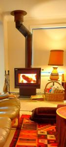 a fireplace in a living room with a fire place at Retro Dunes Venus Bay - WiFi, Netflix, BBQ, linens, pets OK in Venus Bay