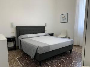 a bedroom with a bed and two tables and a chair at MariMARE in Sestri Levante