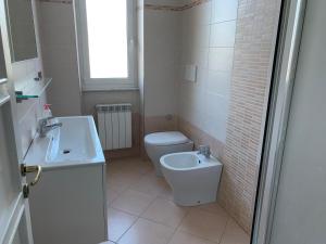 a bathroom with a toilet and a sink at MariMARE in Sestri Levante