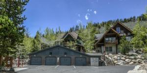 a house with two garage doors in a parking lot at Cabin In The Pines 4 in Keystone