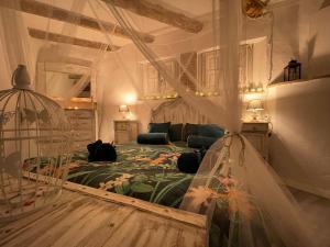 a bedroom with a bed and a bird cage at El Secret de la LLegenda El Drac in Vilavert