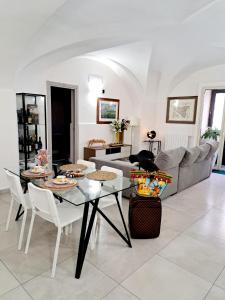 a living room with a table and a couch at Scuto Home in Catania