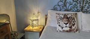 a bedroom with a bed with a tiger pillow on it at Una finestra sul mare accanto alle 5 Terre in Levanto