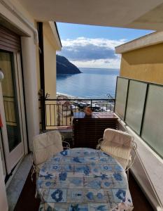 balcone con tavolo, sedie e vista sull'oceano di Una finestra sul mare accanto alle 5 Terre a Levanto