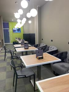 a row of tables and chairs with laptops on them at Hotel Miramonti in Turin