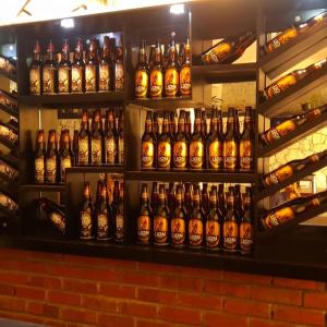 a shelf full of bottles of beer at Capital Regency in Kandy