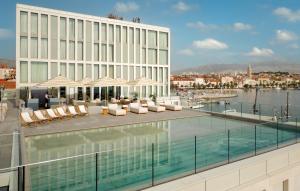 a pool on the roof of a building at Hotel Ambasador in Split