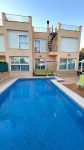 a large swimming pool in front of a building at Casa Xisca in Cala Pi