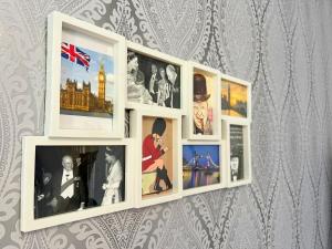 a white picture frame hanging on a wall with photos at Apartament Winston in Szczawno-Zdrój