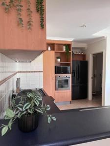 a kitchen with a black counter top and a black refrigerator at Fairway View in Dunsborough