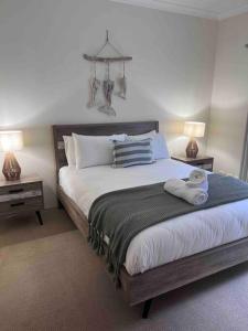 a bedroom with a large bed with two night stands at Fairway View in Dunsborough