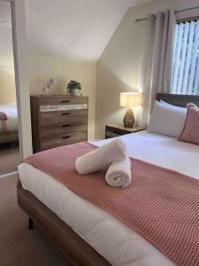 a bedroom with a bed with two towels on it at Fairway View in Dunsborough +13 photos