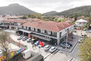 a building with cars parked in a parking lot at RED MOON SUITES in Fethiye