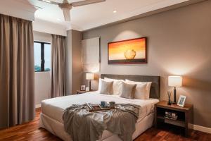 a bedroom with a large white bed in a room at Domitys Bangsar Kuala Lumpur in Kuala Lumpur